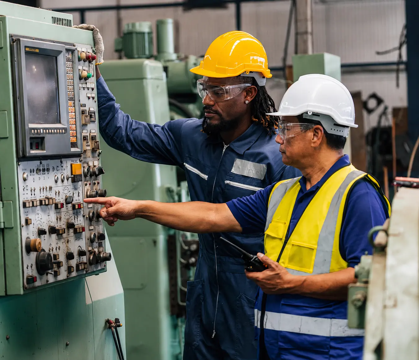 Two People working on a machine